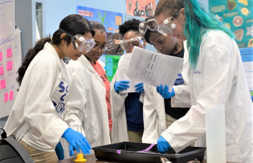 Students at The New Orleans Charter Science and Mathematics High School participate in a science experiment.